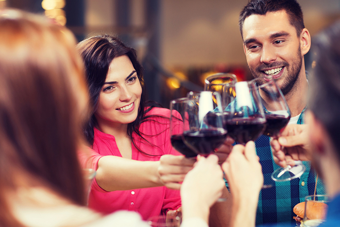 people holding wine glasses